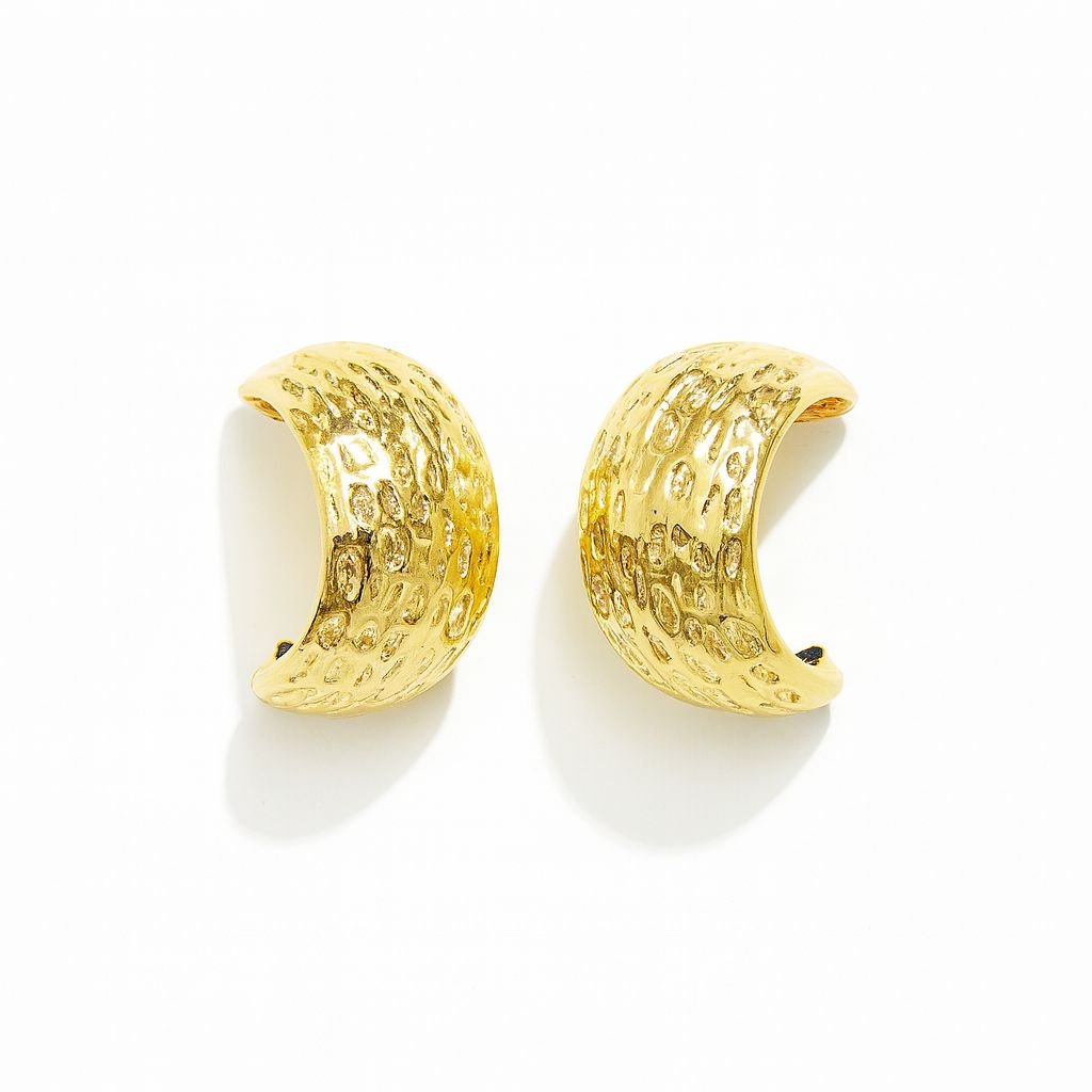 Gold Toned Wide Huggie Hoop Earrings with an all-over hammered or dimpled surface texture.
